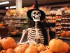 Skeleton in witch costume used as a decoration for Halloween in grocery store.