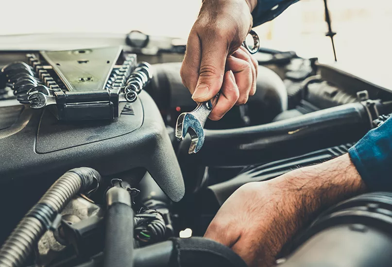 Auto car repair service center. Mechanic examining car suspension