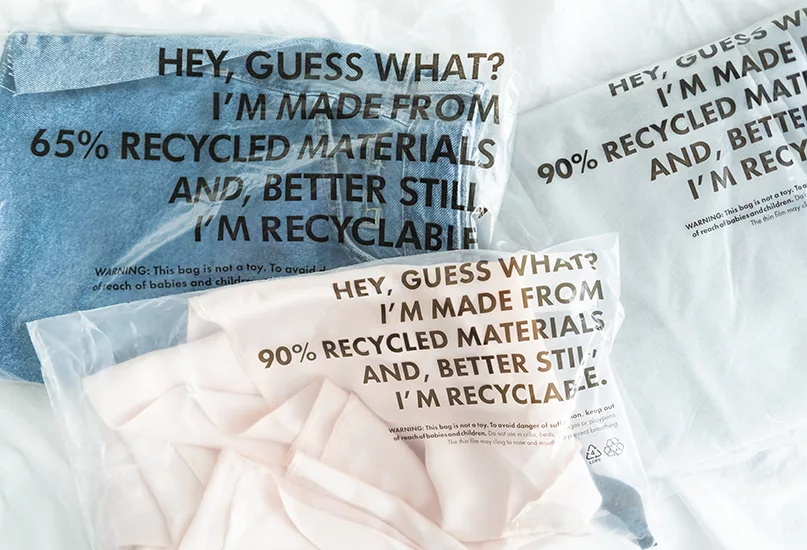 Clothes in plastic bag with tag recycled materials and recyclable. zero waste concept.