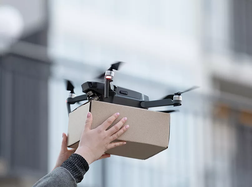 New drone with package box, delivery service modern electronic device, blurred background